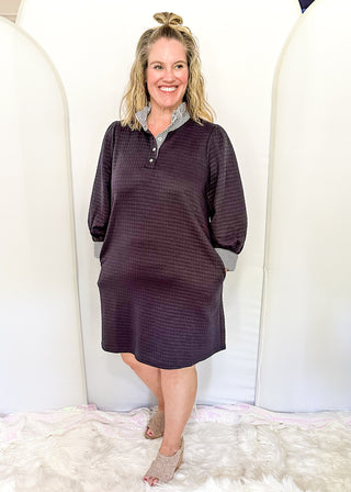 Navy quilted 3/4 length sleeve dress with navy and white stripe ruffle collar and matching sleeve detail.  Knee length
