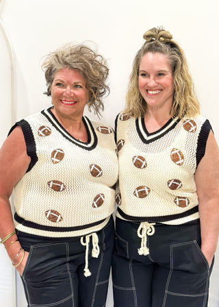Cream open weave sleeveless sweater - need to wear something underneath - football sequin patches and black and cream varsity style trim around v-neck and bottom banding.