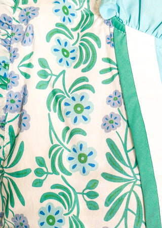 Close up of floral print top with decorative neckline and short ruffle sleeves