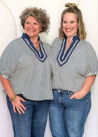 Models wearing an indigo-colored Entro dolman striped top with contrast trim, styled in a relaxed, casual fit.