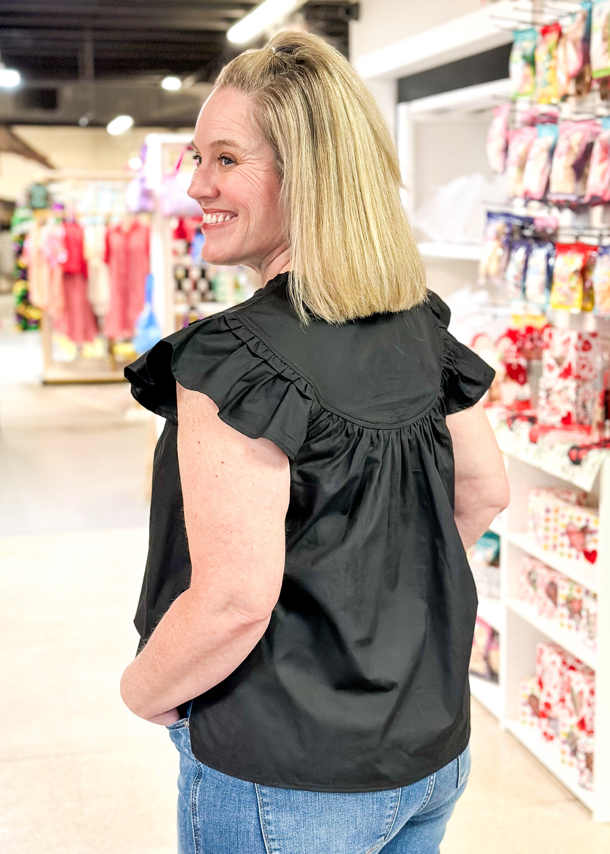 notched v-neck ruffle short sleeve top with ruffle neck and seam above the chest - black