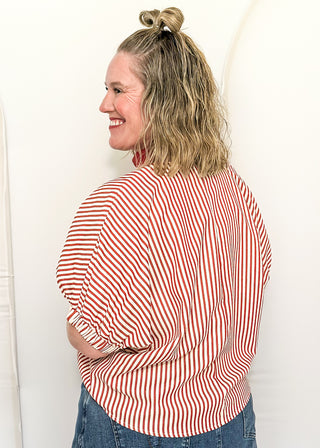 Model wearing a Brick-colored Entro dolman striped top with contrast trim, styled in a relaxed, casual fit.