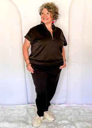 Black elastic waist jogger pants with cuffed ankles