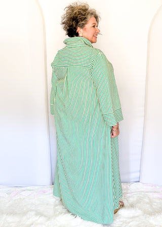 Green vertical striped collared dress with button-down front with green contrast, 3/4 sleeves, midi length, and side pockets.