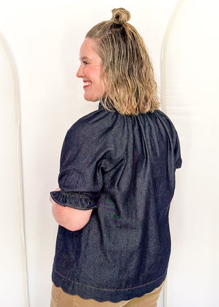 Women's indigo denim-look blouse featuring a smocked split neckline, puff sleeves, and a relaxed fit.