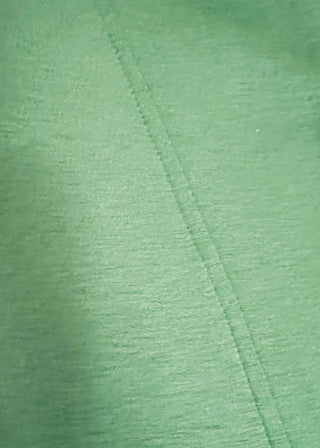 close up of green scuba fabric athleisure top with zip detail and modern silhouette