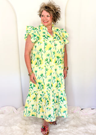 Women’s flowy maxi dress with green and yellow floral pattern and ruffle sleeve detail.