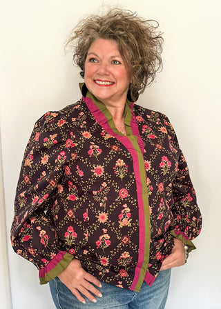 Deep navy floral ruffle trim long sleeve top with rich pink and olive accents.