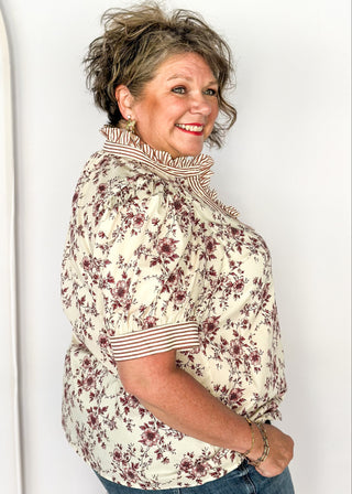 Ivory with small rust colored florals-short sleeve button up top. Rust and ivory stripe ruffle collar and sleeve binding.  