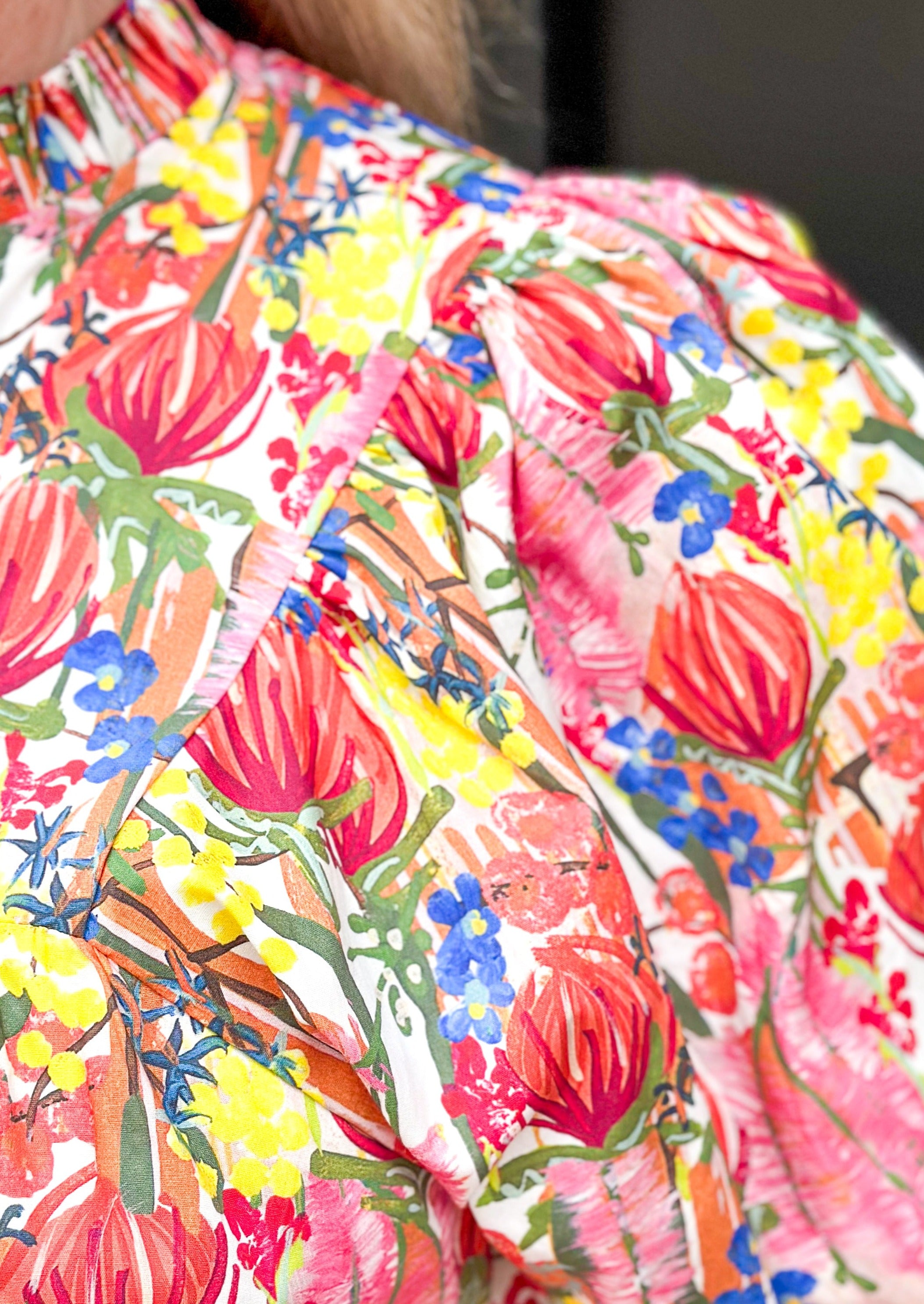 floral print short puff sleeve top with banded cuff w/button - v-neck - ruffle color - florals in red, yellow, pinks, blue