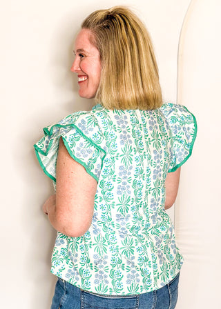 Floral print top with decorative neckline and short ruffle sleeves