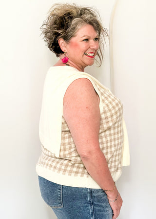 Sleeveless green checkered sweater with faux wrap in cream.