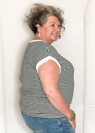 Black and white striped short sleeve top with white banding on sleeve and collar. 