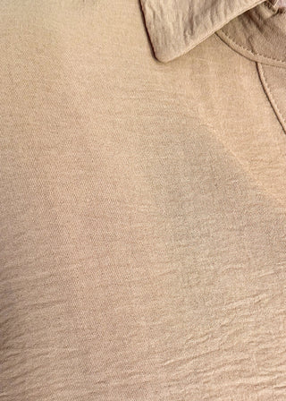 close up of light brown collared top with v-neckline