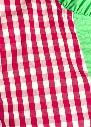 Close up of Women’s gingham blouse with decorative buttons and statement neckline detail.