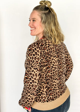Long sleeve sweater in bold leopard print and colorful stripe collar.