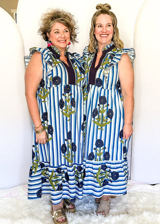 Blue and white striped midi dress with dark blue floral print, flutter sleeves, contrast V-neckline, and a flowy tiered hem