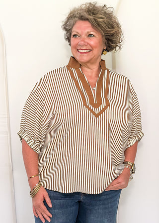Model wearing the Dolman Striped Brown Top featuring a relaxed fit, classic stripe pattern, and contrasting trim details.