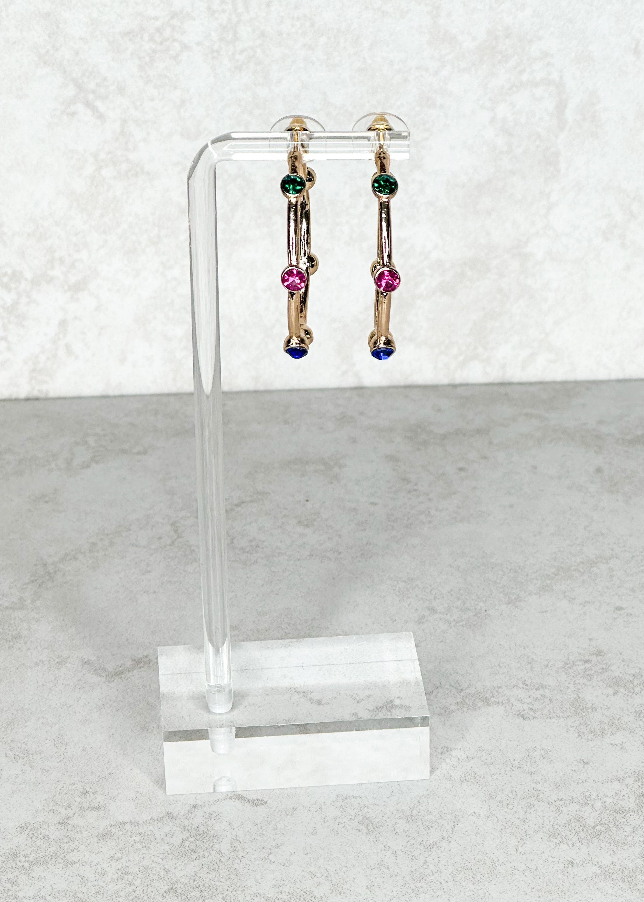 Gold with multi-colored jewels, open hoop, post back earrings.