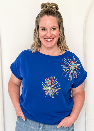 blue short sleeve top with 2 sequin firework bursts.
