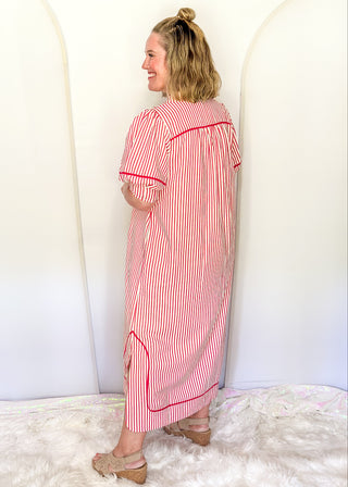 Raspberry and white vertical stripes on a short sleeve v neck midi dress. 