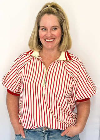 Women’s red striped short sleeve 1/4 zip top with lightweight fabric, stripe elastic sleeve and collar detail.