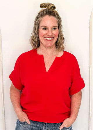 Solid textured blouse with a V-notch neckline, short sleeves