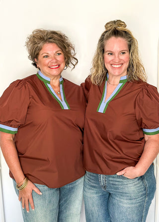 Brown Puff Sleeve top with short sleeves and v-neck.  Contrast binding in green and blue on sleeve and collar. 