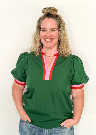 Green Puff Sleeve top with short sleeves and v-neck.  Contrast binding in pink and orange on sleeve and collar. 