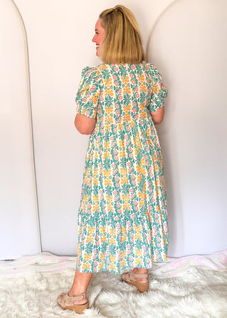 Floral midi dress with contrast neckline, short puff sleeves, and tiered skirt