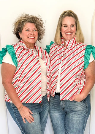 Holiday puffer vest with diagonal red, green, pink and white stripes. Snap closures, ruffle sleeves and front pockets.