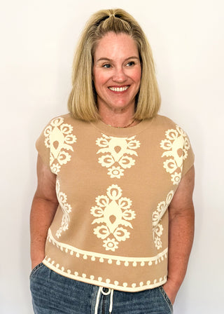 Taupe knit sweater with ivory woven pattern and short sleeves.