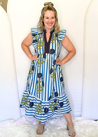 Blue and white striped midi dress with dark blue floral print, flutter sleeves, contrast V-neckline, and a flowy tiered hem