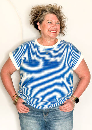 Blue and white striped short sleeve top with white banding on sleeve and collar. 