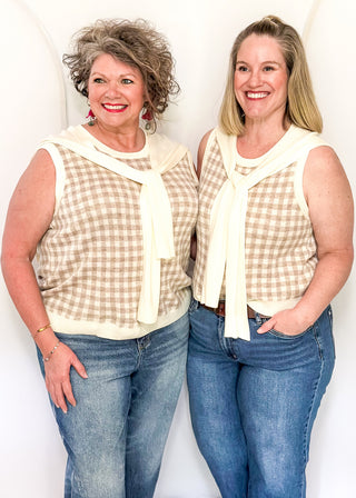 Sleeveless oatmeal checkered sweater with faux wrap in cream.