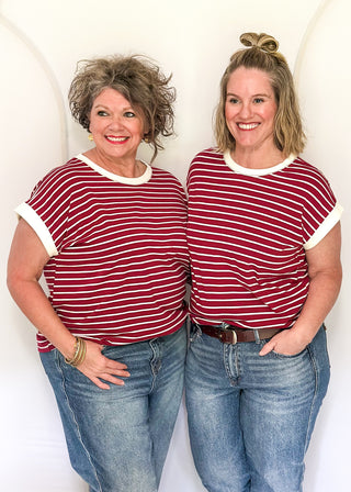 wide striped top with cuffed sleeves, and white banded rounded neckline.