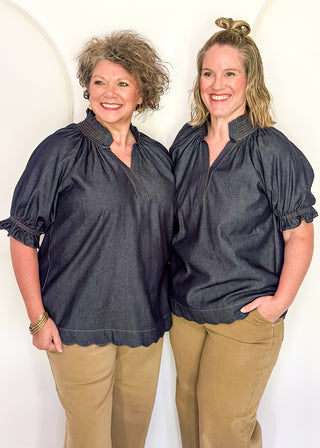 Women's indigo denim-look blouse featuring a smocked split neckline, puff sleeves, and a relaxed fit.