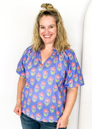 periwinkle floral top with puff short sleeves and v-neck