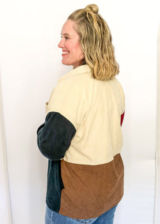 Colorblock corduroy shacket with front and side pockets. featuring cream, camel, forest green, and dark red panels, long sleeves, and snap-front closure