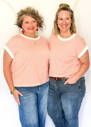 Coral and white stripe short sleeve top with white contrast banding on the collar and sleeves. 