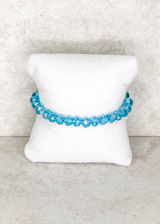 Aqua beaded bracelet displayed on a stand 
