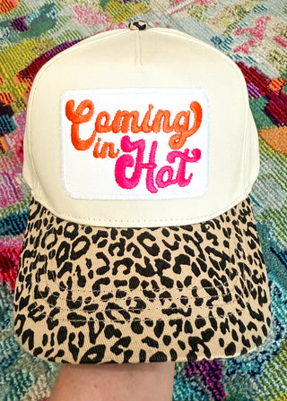 Snap-back canvas hat with leopard bill.  Embroidered white patch with "Coming in" (orange), "Hot" (Hot pink)
