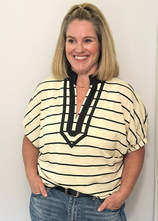 Cream and black striped dolman top with black trim and flowy short sleeves.