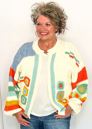 woman modeling a colorful sweater cardigan