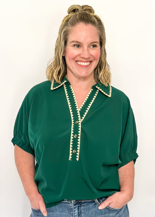 Emerald green short-sleeve blouse with contrast stitched collar and neckline, ruched sleeves, and a loose, relaxed fit