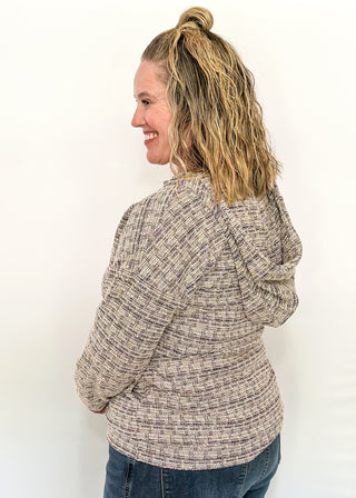 tweed hooded long sleeve top with pockets.  Colors of purple, cream, gray