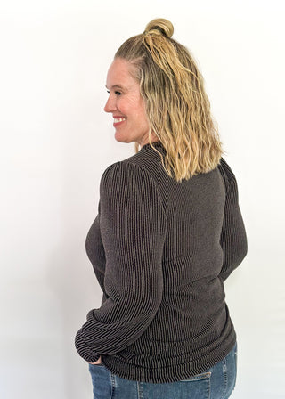 long sleeve ribbed top with cuff sleeve and small puff detail in shoulder. crew neck. 