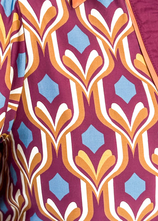 Wine-colored geometric print dress with collared neckline, tiered hem, and 3/4 sleeves.