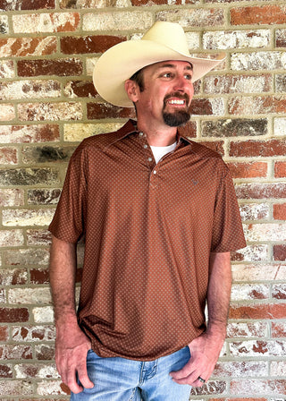 brown colored performance polo shirt with a small design on it worn by a man in a cowboy hat