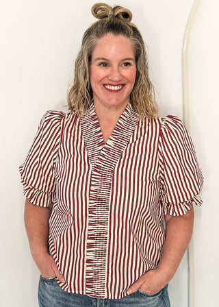 woman wearing striped short sleeve top and jeans. 